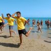 Persone che ballano sulla spiaggia vicino al mare.